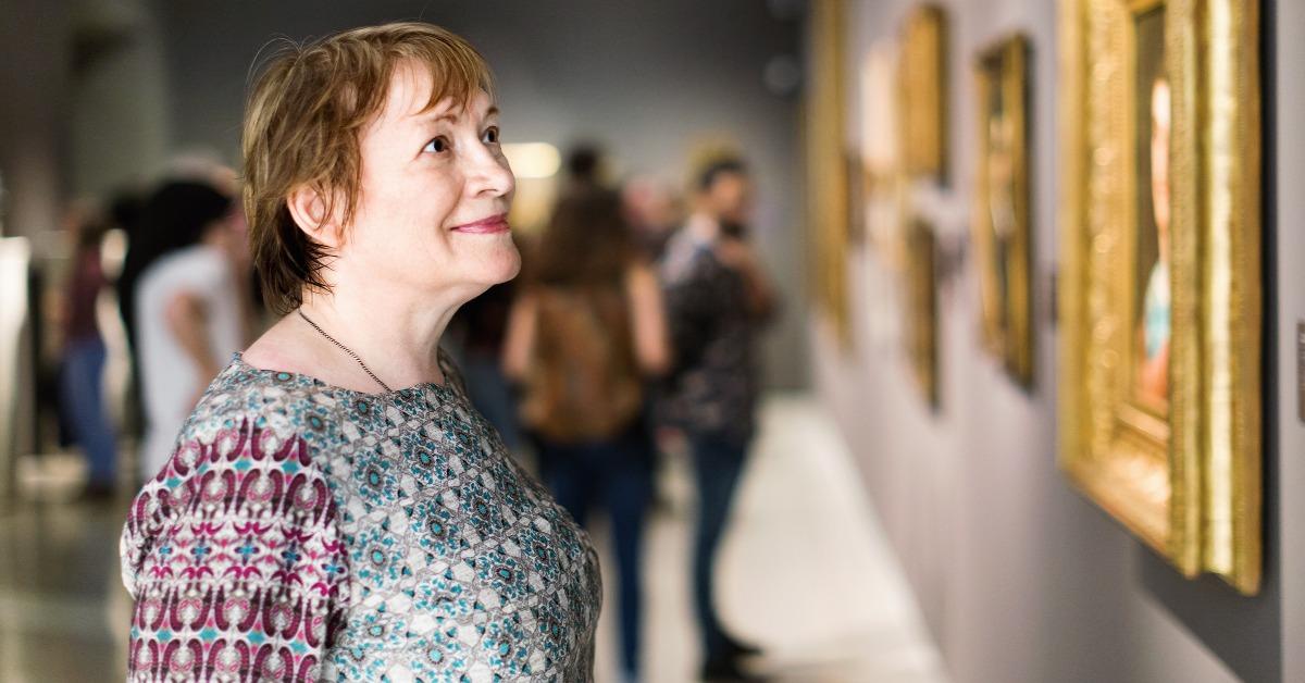 attentive senior woman visiting museum