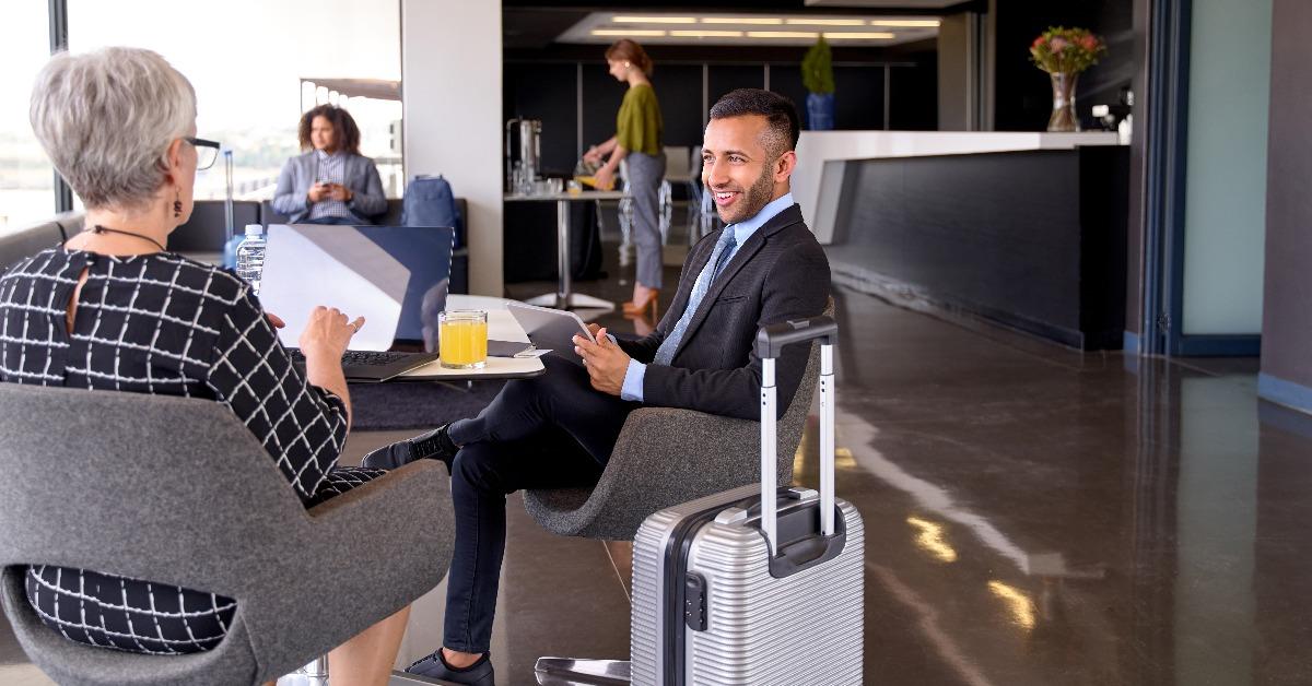 diverse business partners sitting in modern airport lounge