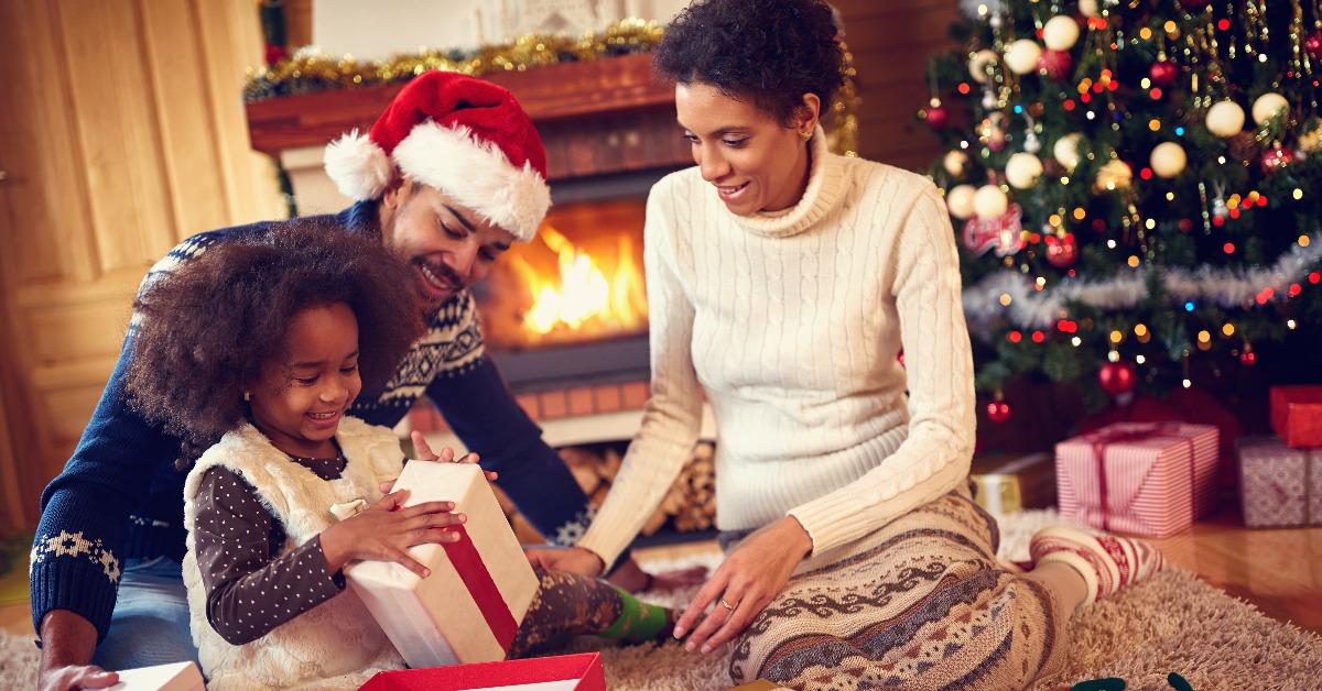 happy family in Christmas morning opening present