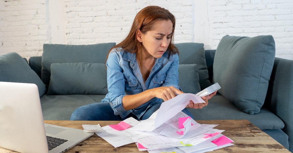 worried young single mother feeling stressed while working through finances