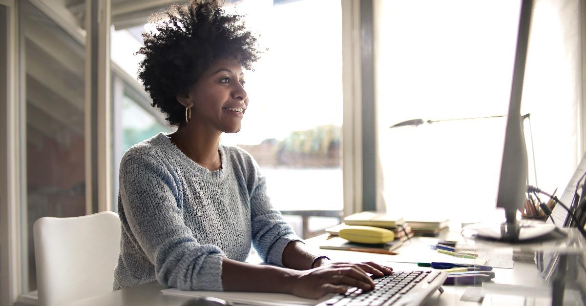 young woman working on computer at home