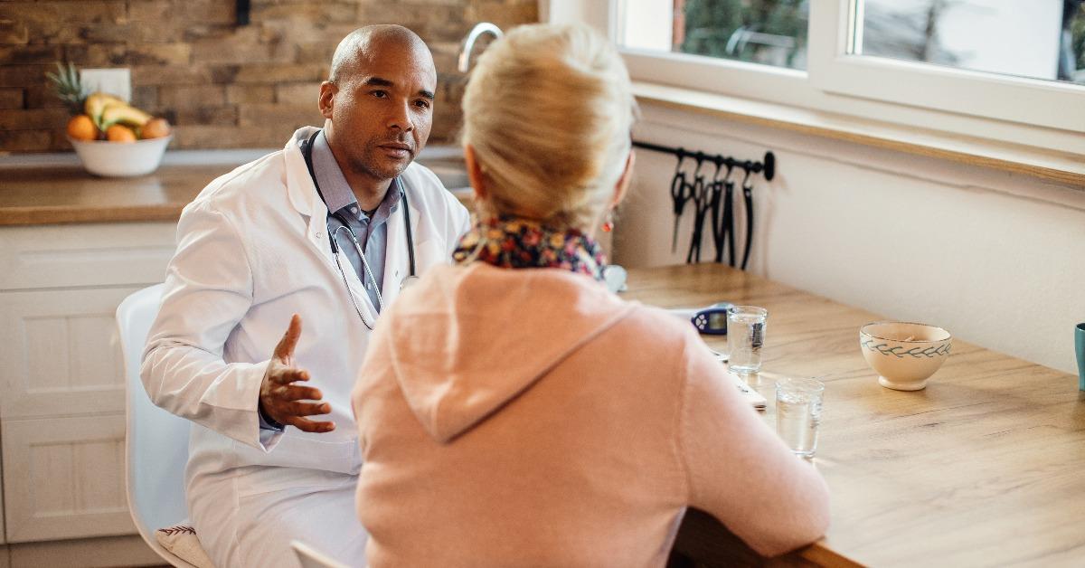 african American doctor communicating with senior woman 