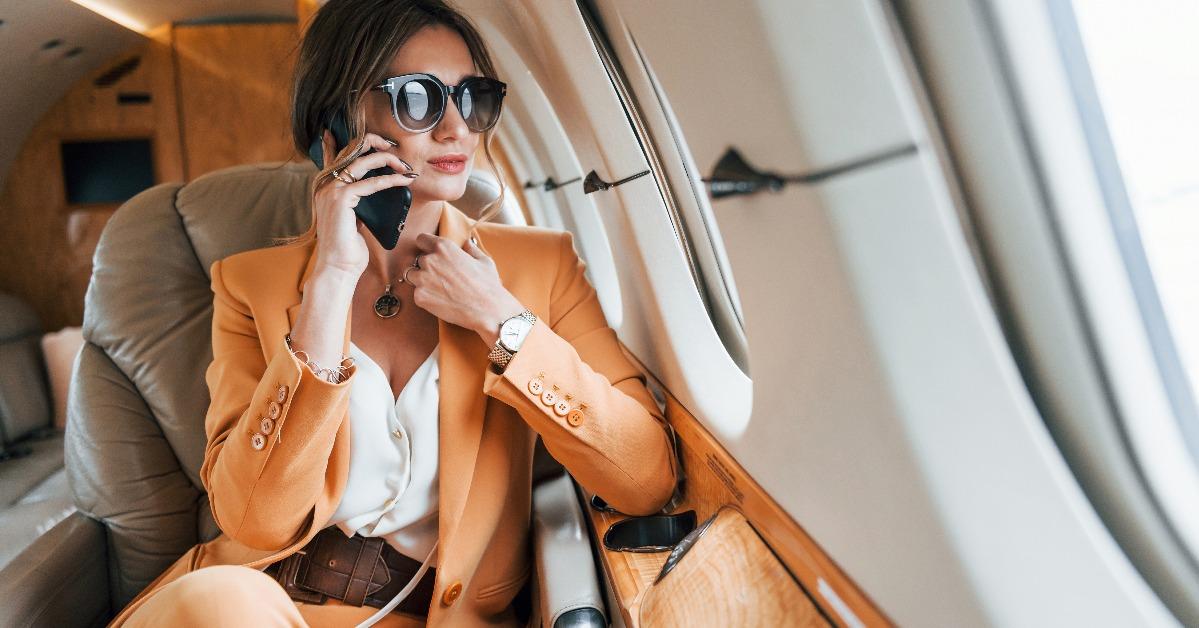 young passenger woman in yellow clothes is flying in the plane
