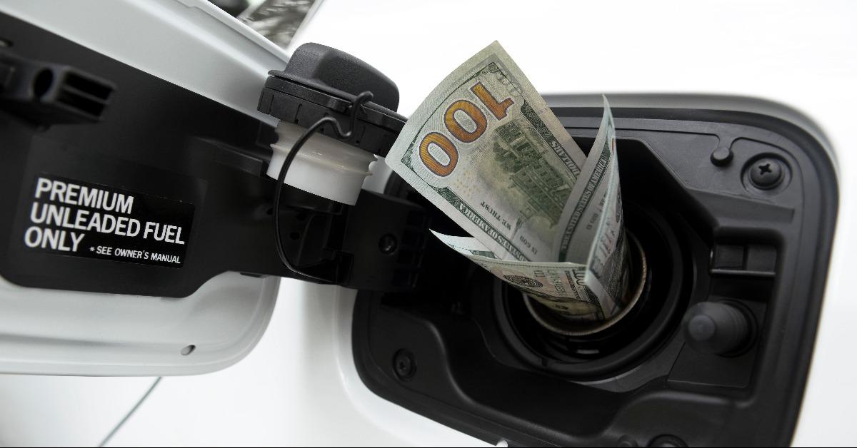 twenty dollar bills sticking out of a car gas cap