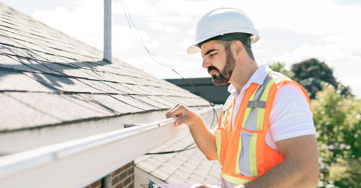 man in a hard hat fixing the roof