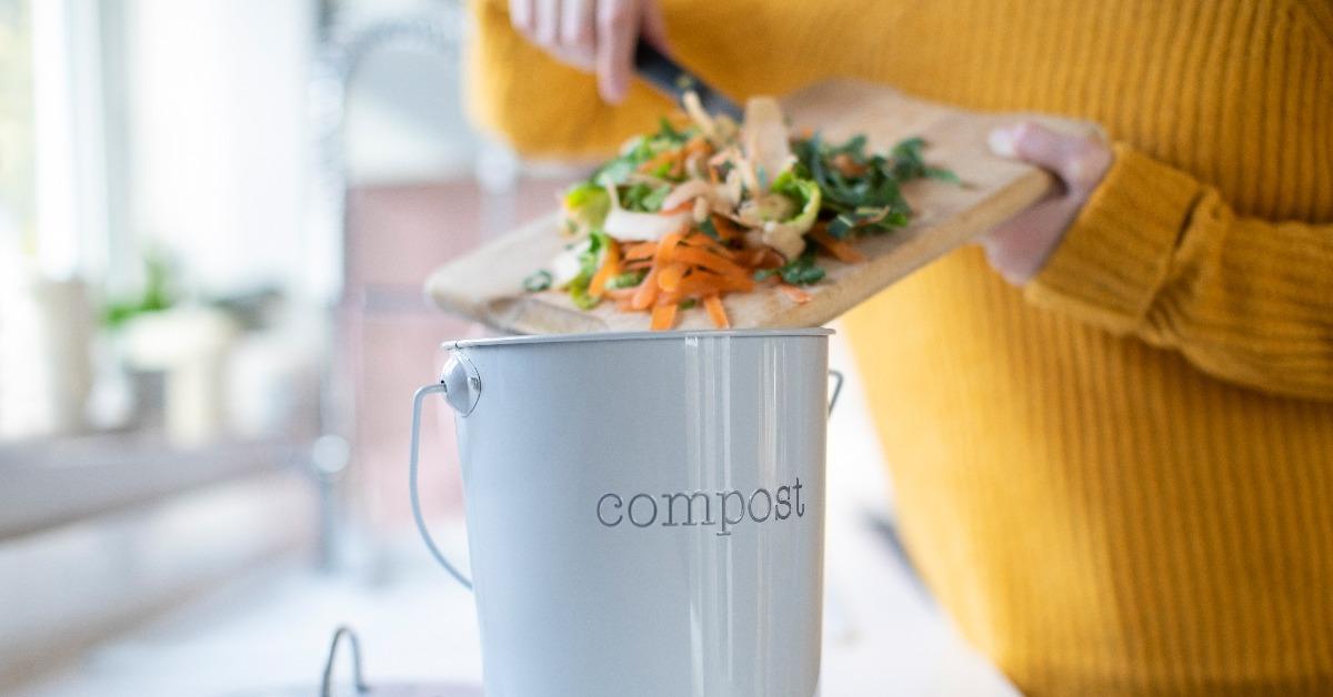 woman making compost from vegetable leftovers