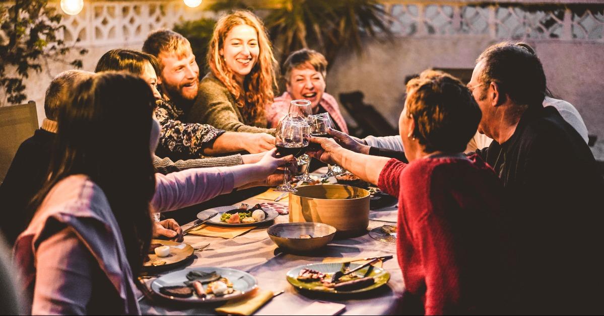 family cheering with red wine at barbecue dinner outdoor