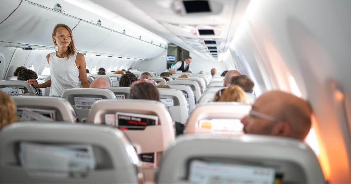 young woman aboard an airplane during a long haul commercial flight