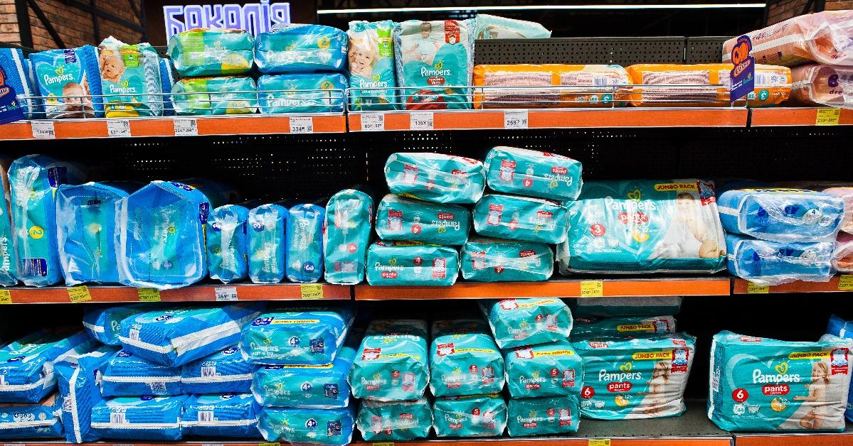 Pampers and other diapers on the shelf of store
