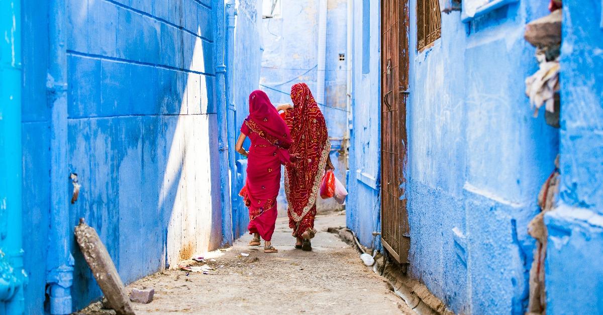 two women dressed in the traditional Indian Saree