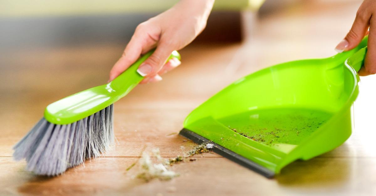 woman cleaning and sweeping floor at home 