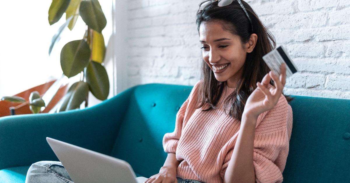 pretty young woman shopping online with credit card