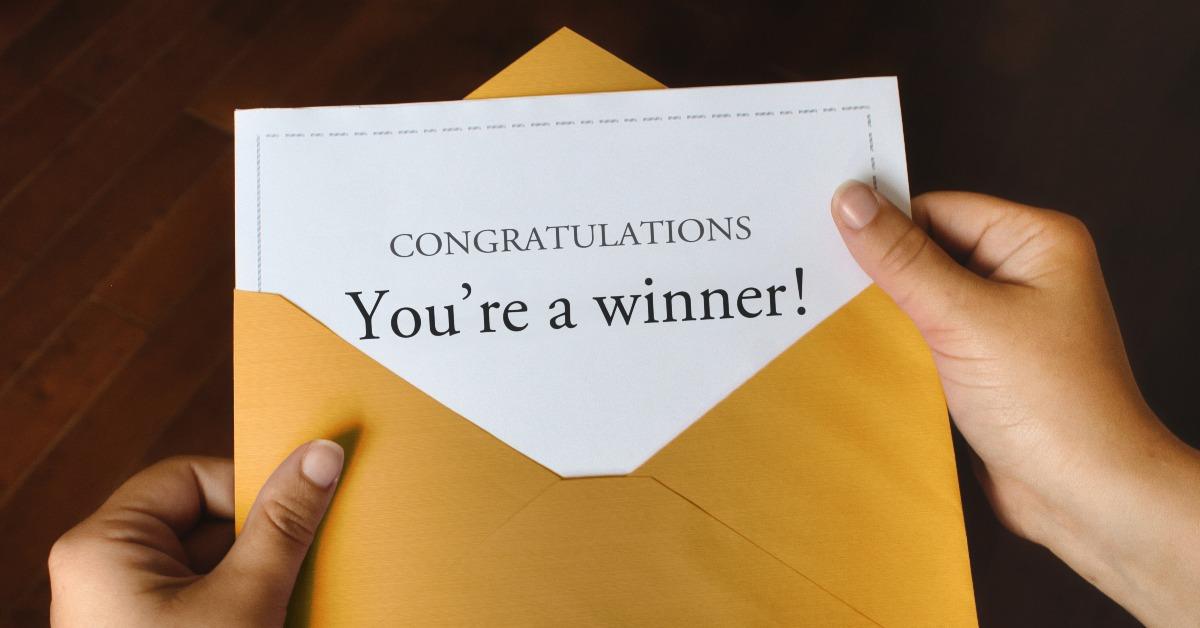 open shiny gold envelope with a letter that says Congratulations You're a winner