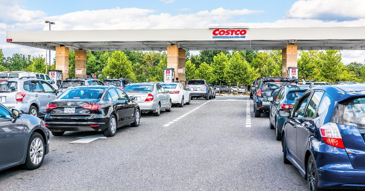 people in cars waiting in long line queue lanes to fill up vehicles with gas