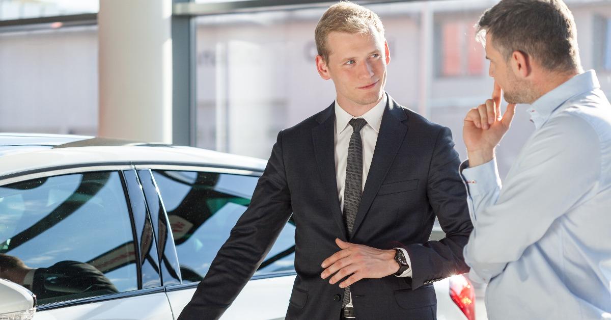 salesman presenting auto to customer