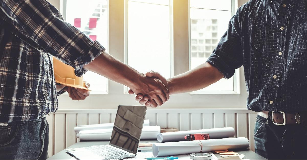 Engineer and contractor shaking hands