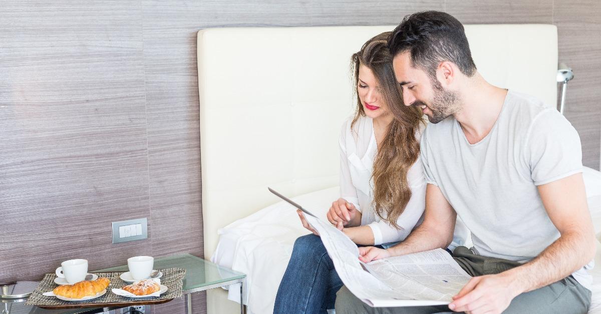 couple with digital tablet and newspaper