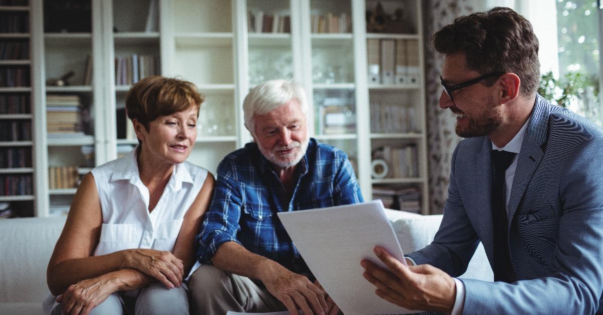Senior couple planning their investments with financial advisor