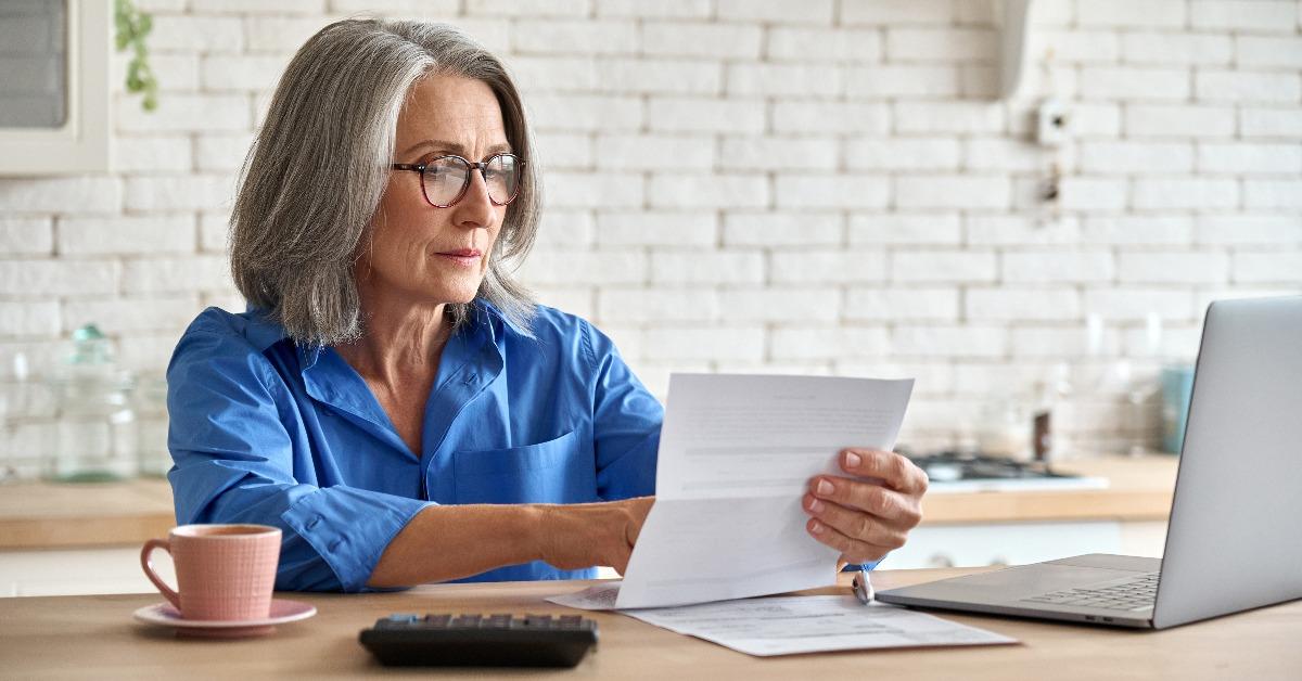 Serious middle aged woman calculating bank loan payments