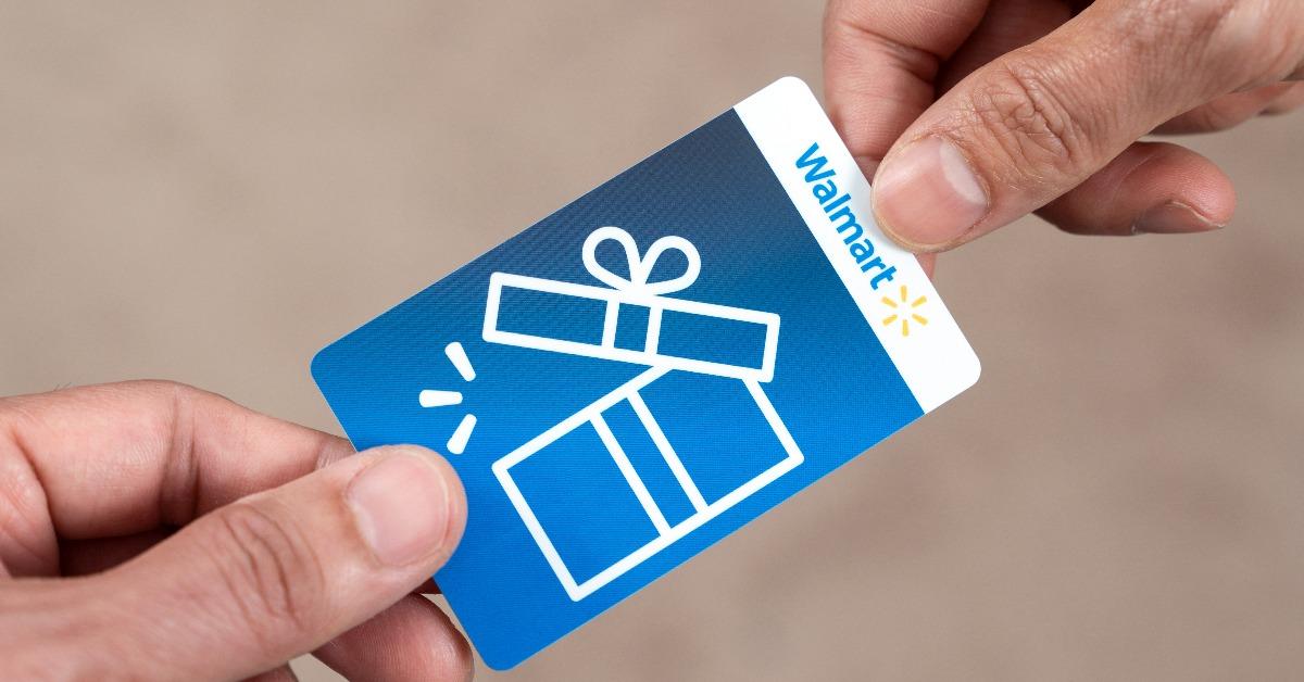 Hand giving out a Walmart gift card 