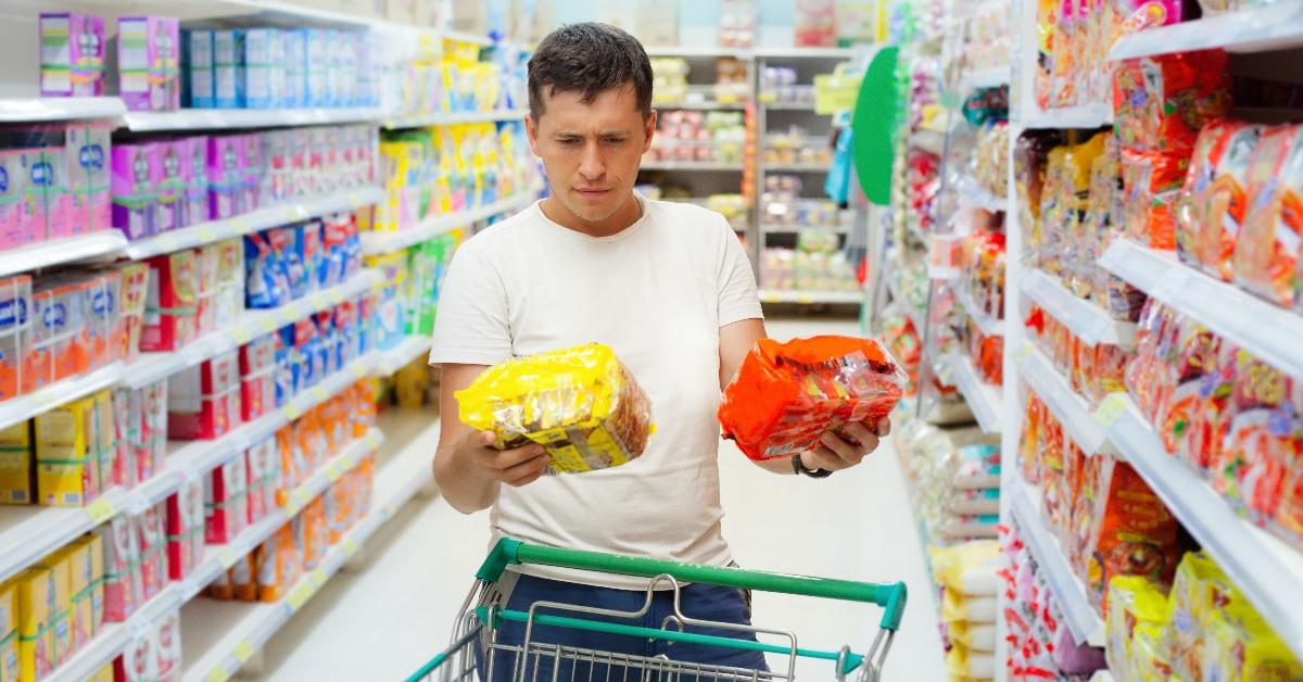 Young caucasian man make choose between two similar goods