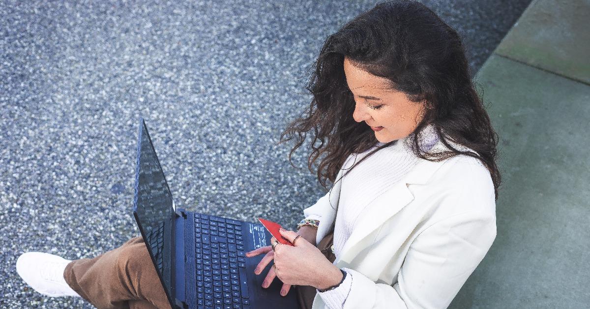 Young caucasian woman using a red credit card