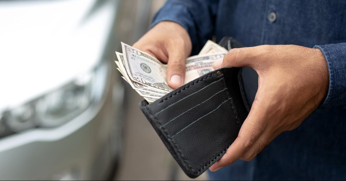 hands of a man taking money out of a wallet