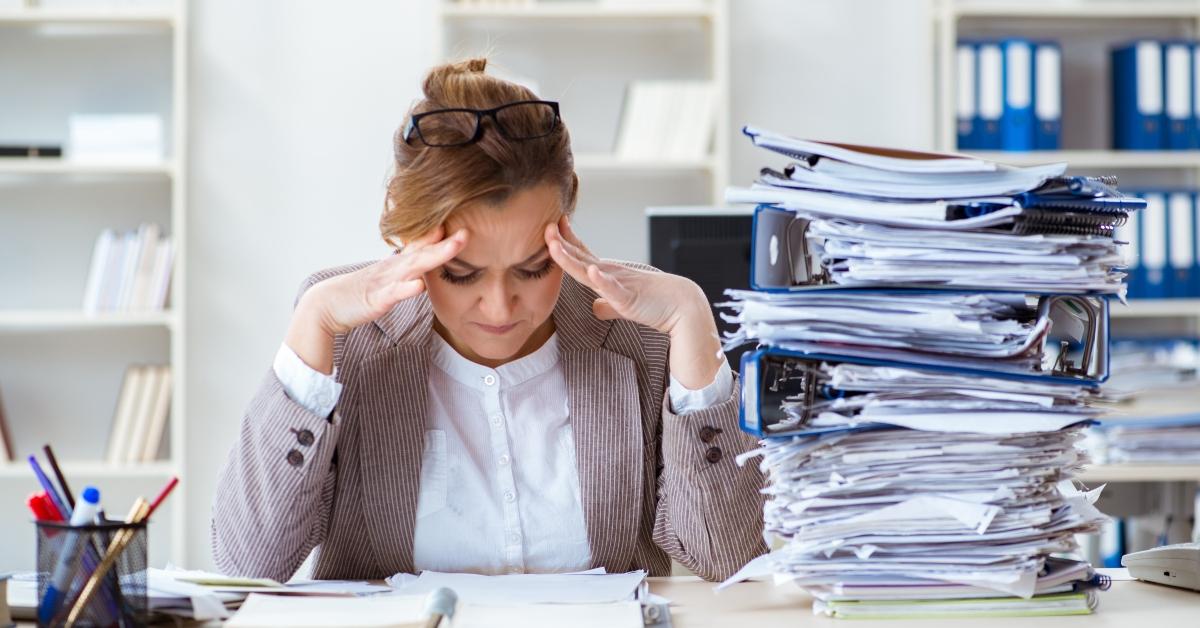Woman with pile of paperwork