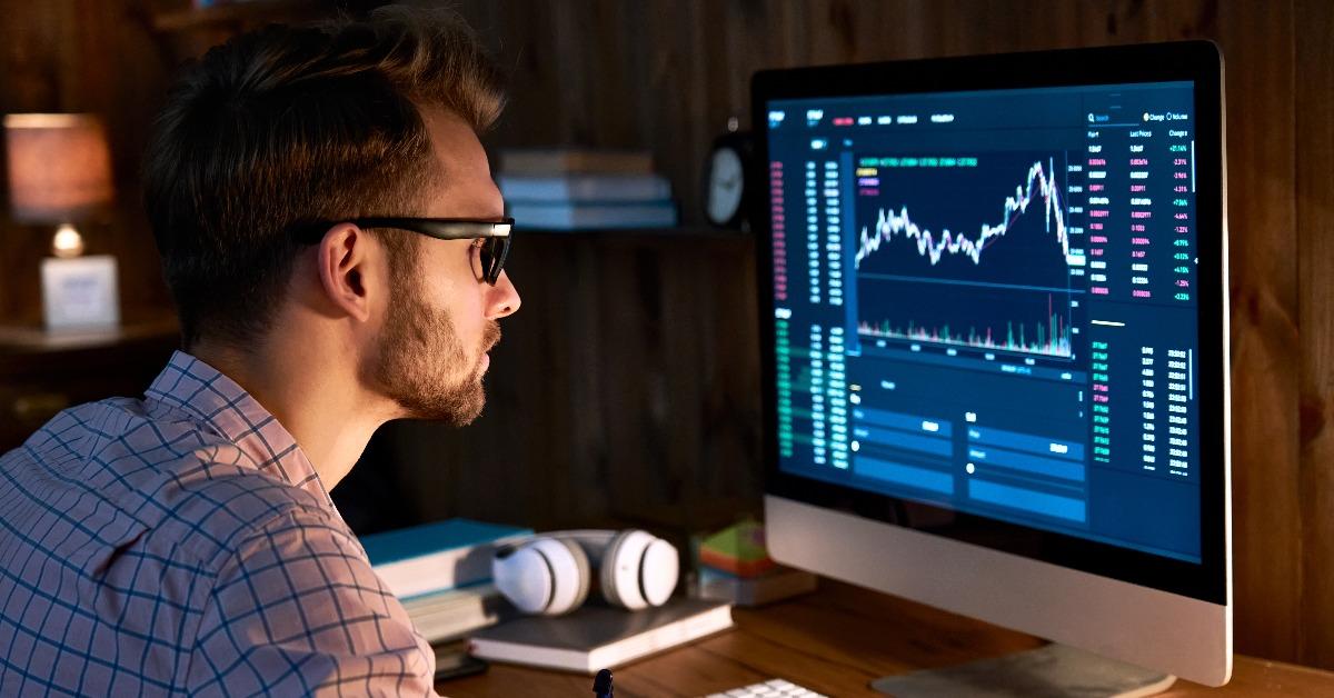 trader analyst looking at computer monitor