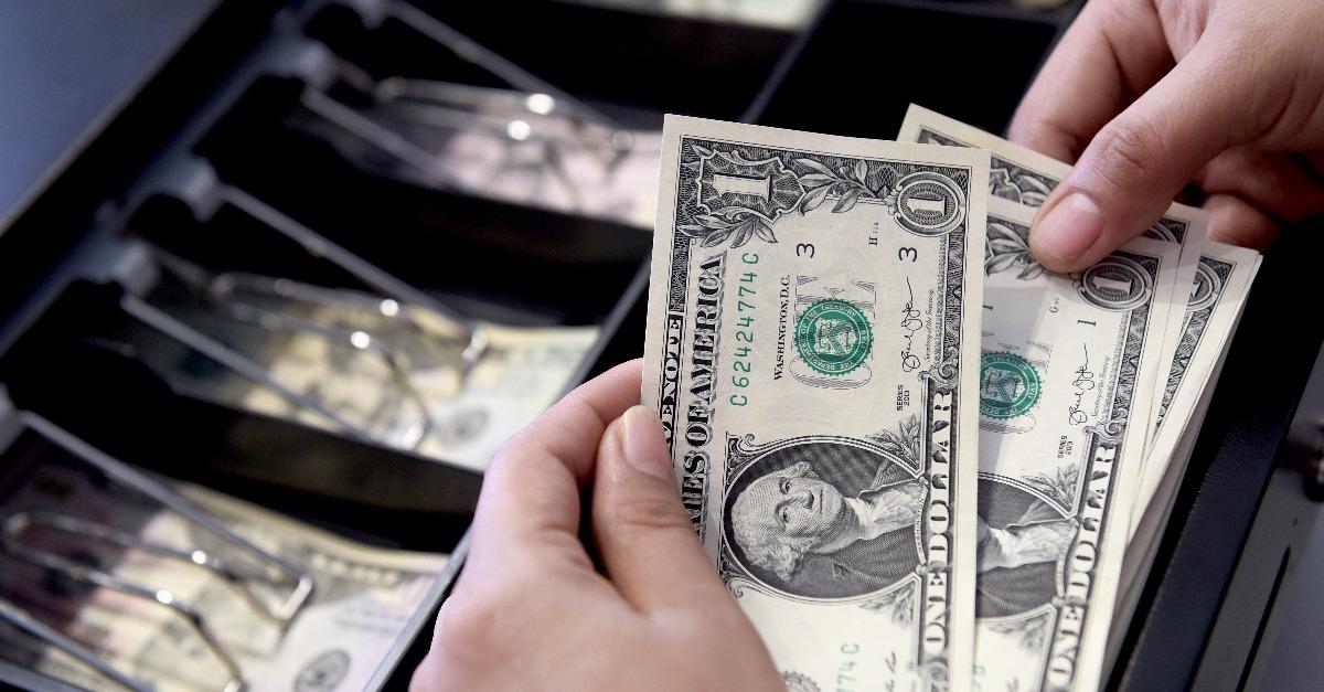 cashier searching for change in cash