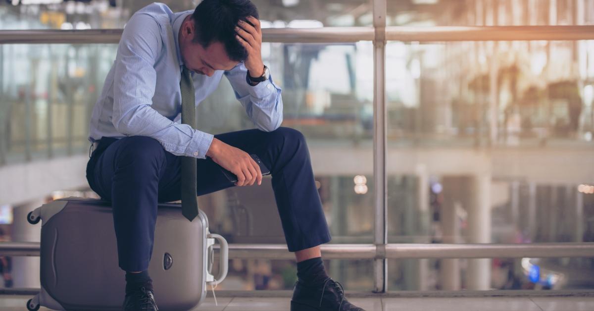 Businessman sitting on suitcase