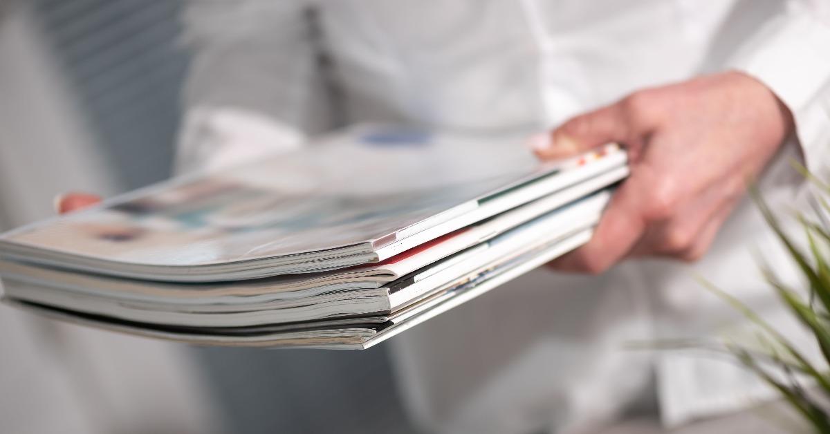 Female hands holding magazines