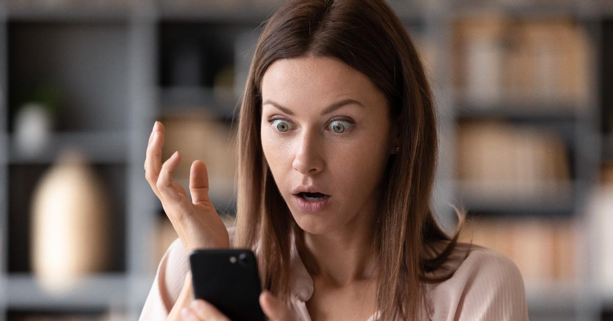 frustrated lady reading sms with unbelievable news on smartphone