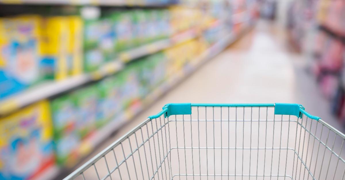 Shopping cart view in Supermarket aisle with diaper shelves