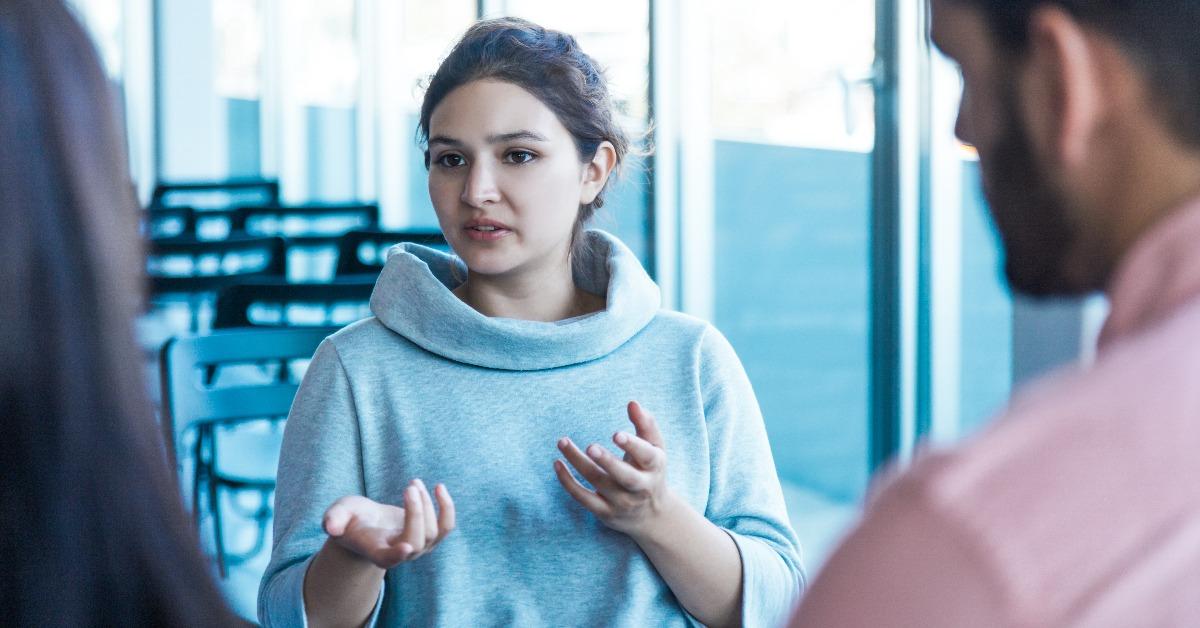 young female entrepreneur discussing startup with colleagues