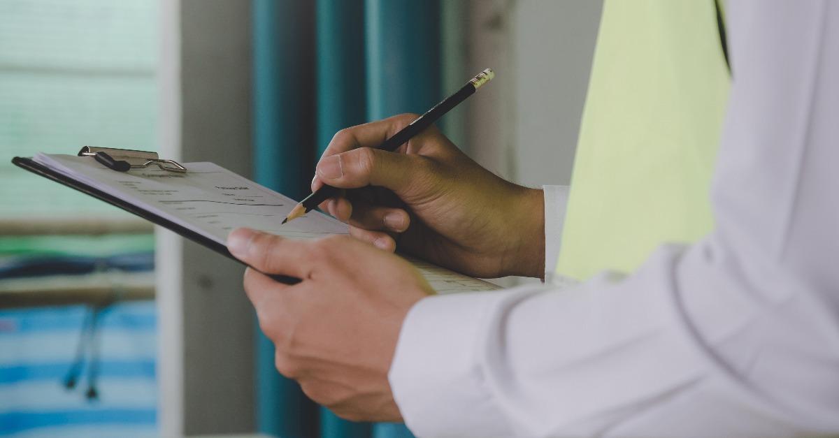 inspector checking and inspecting with clipboard