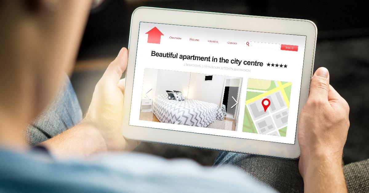 Man search apartments and houses online with mobile device