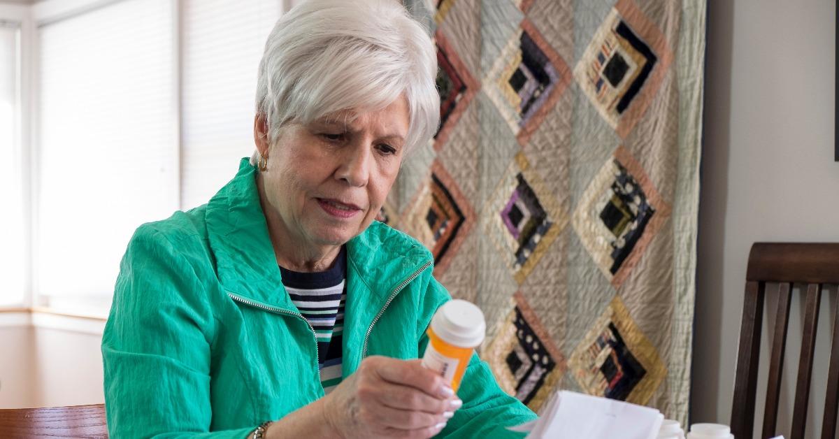 mature woman looking over medical bills