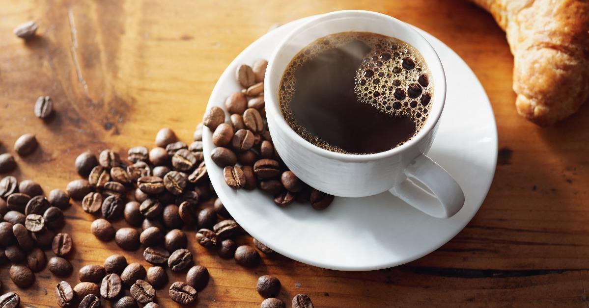 Cup of hot coffee on wooden table