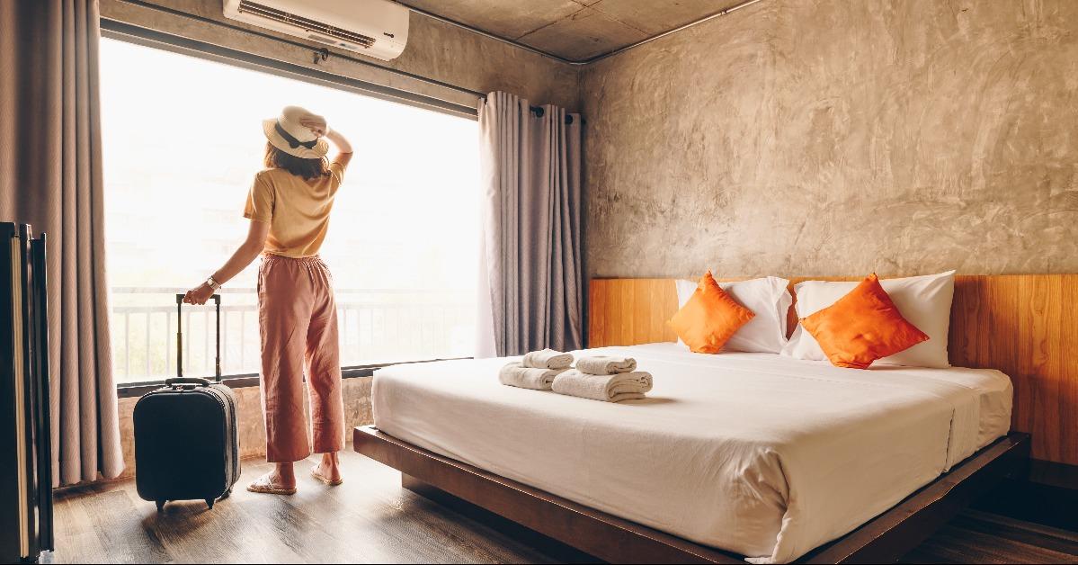 tourist woman standing nearly window