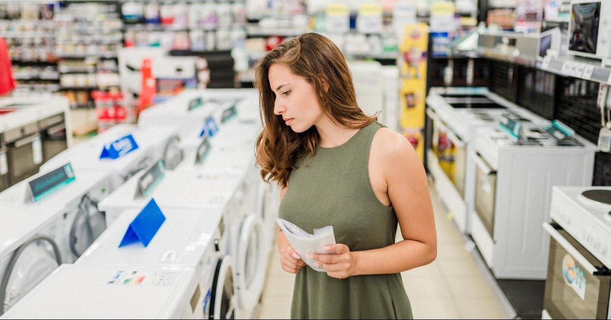 woman buys washing machine in a store