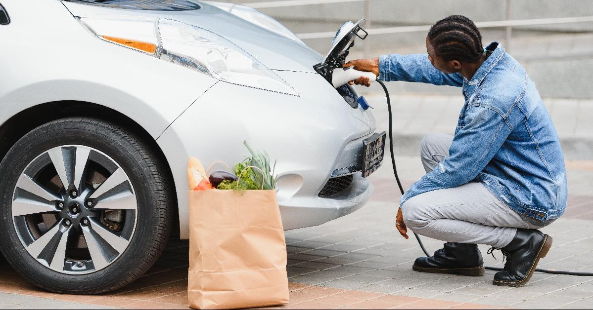 man charging his electric car