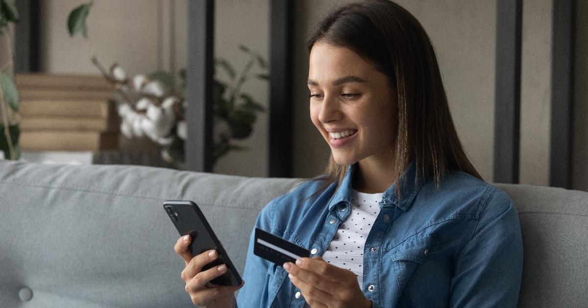 young female uses credit card to buy online