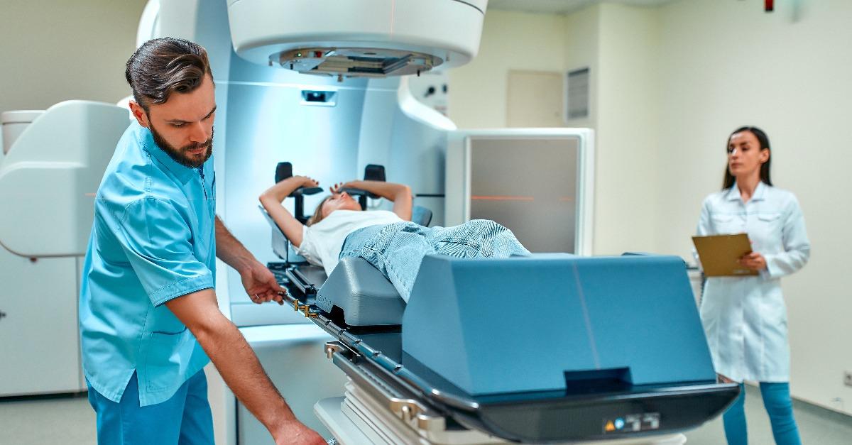 woman is undergoing radiation therapy for cancer under the supervision of doctors 