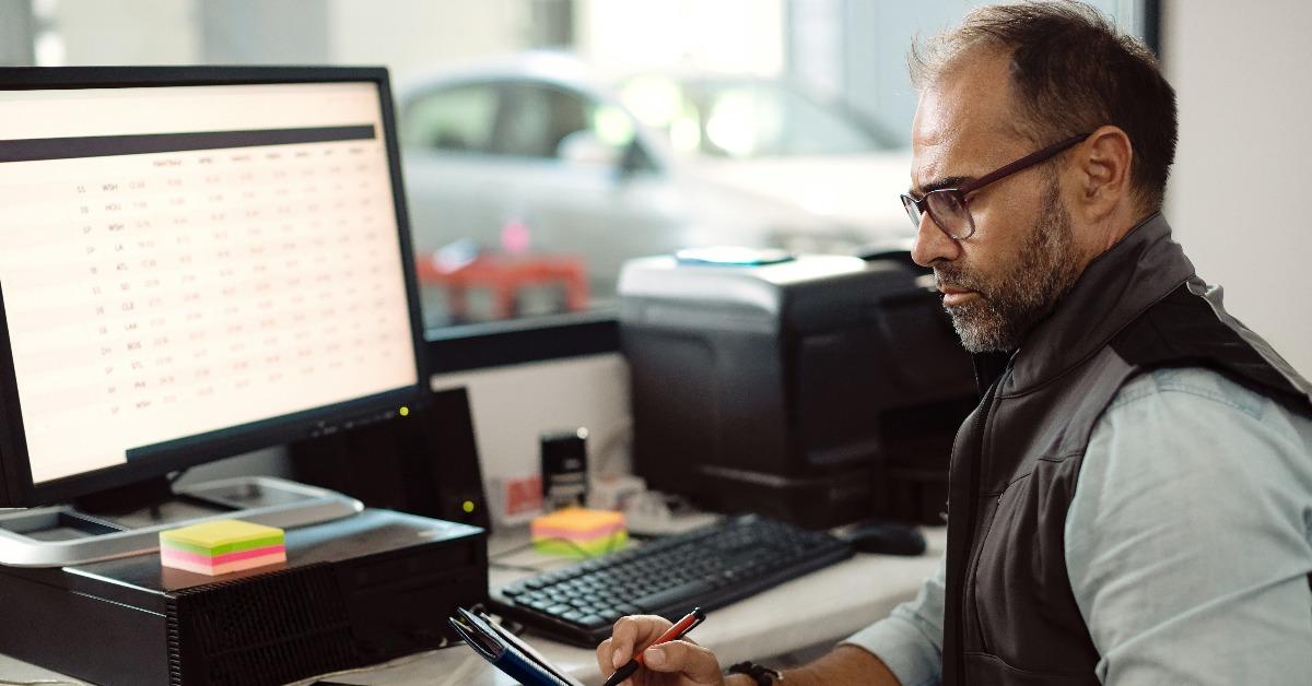 mechanic going through paperwork while working in the office