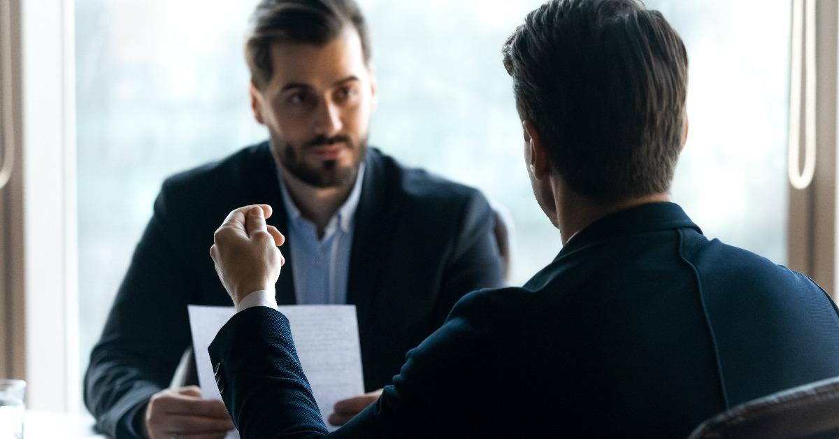 man in formal wear answering questions of hr manager 
