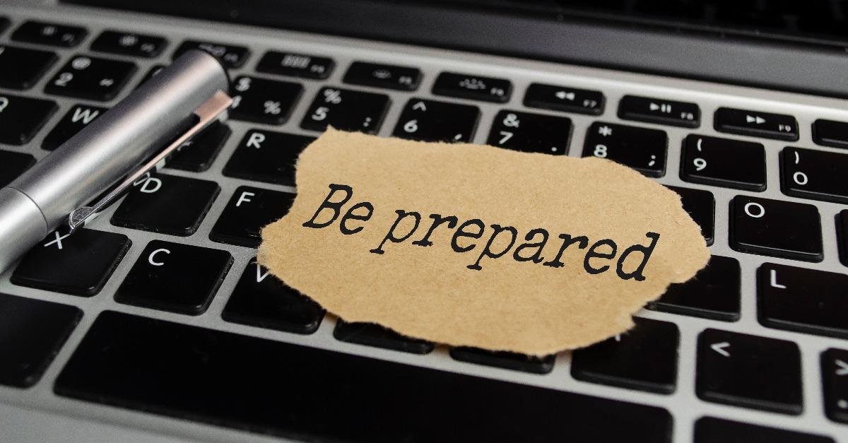 text Be prepared appearing behind torn brown paper