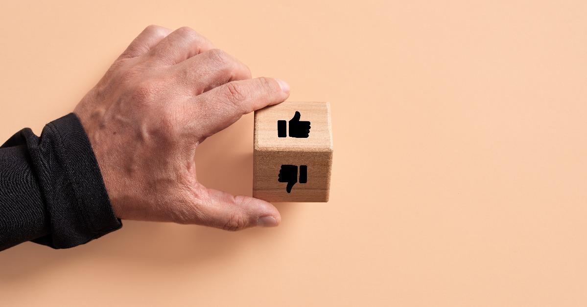  wooden cube with like and dislike symbols