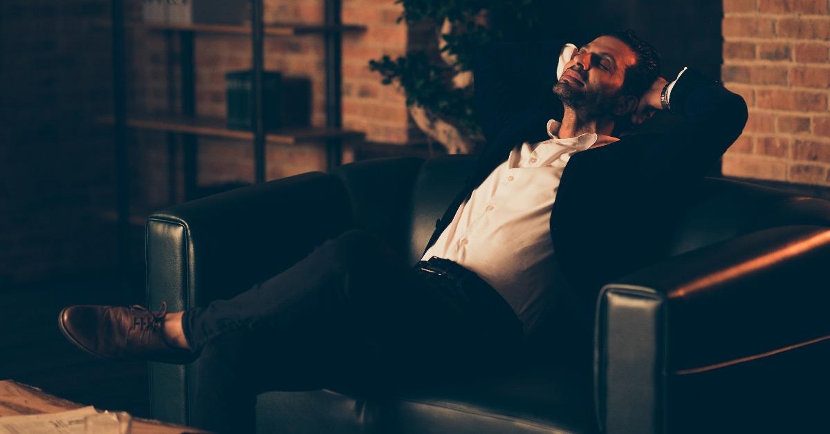 handsome man sitting on a leather couch