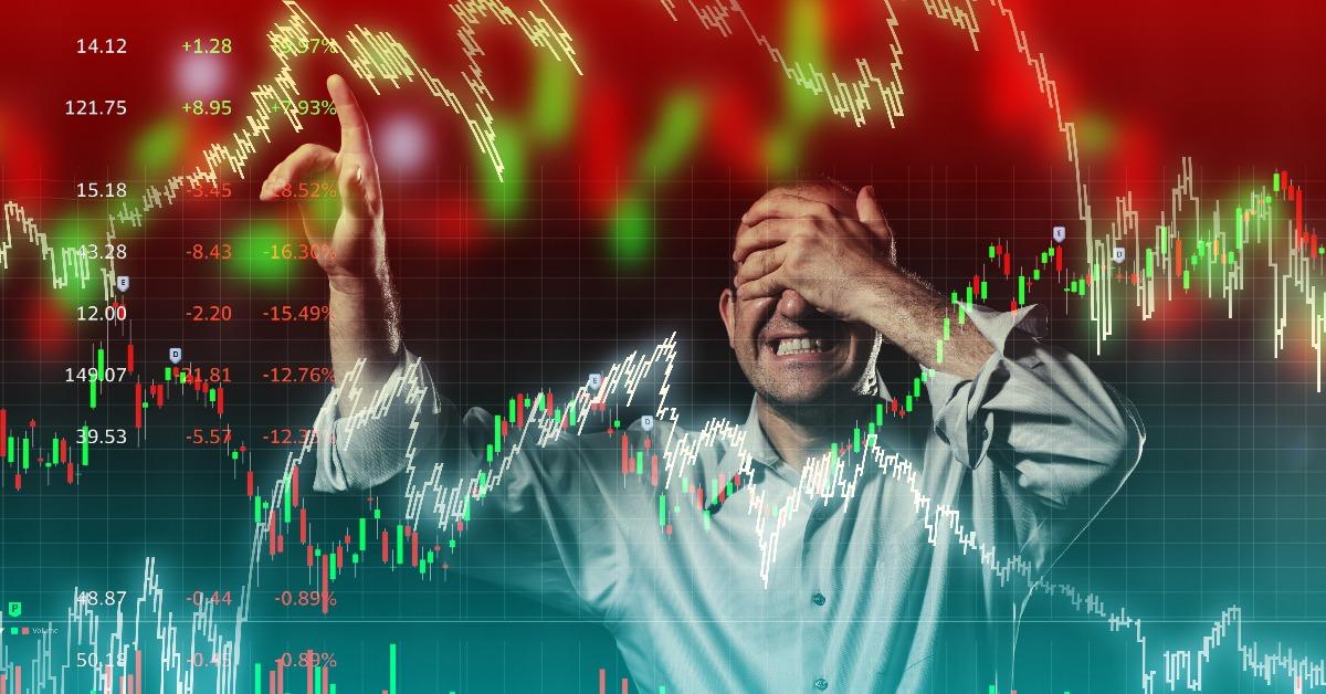 scared trader pointing to volatile stock market chart
